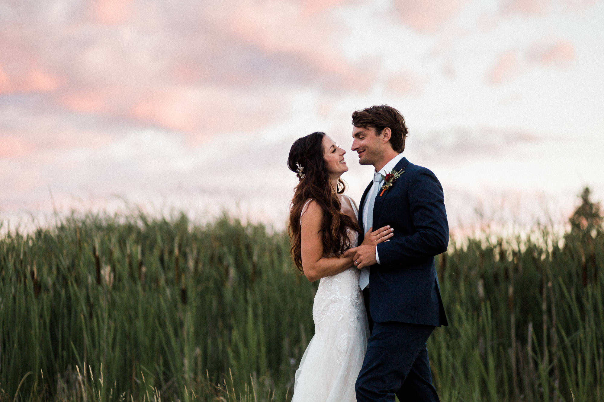 Bride and groom embrace at sunset at Broken Top Club in Bend, Oregon