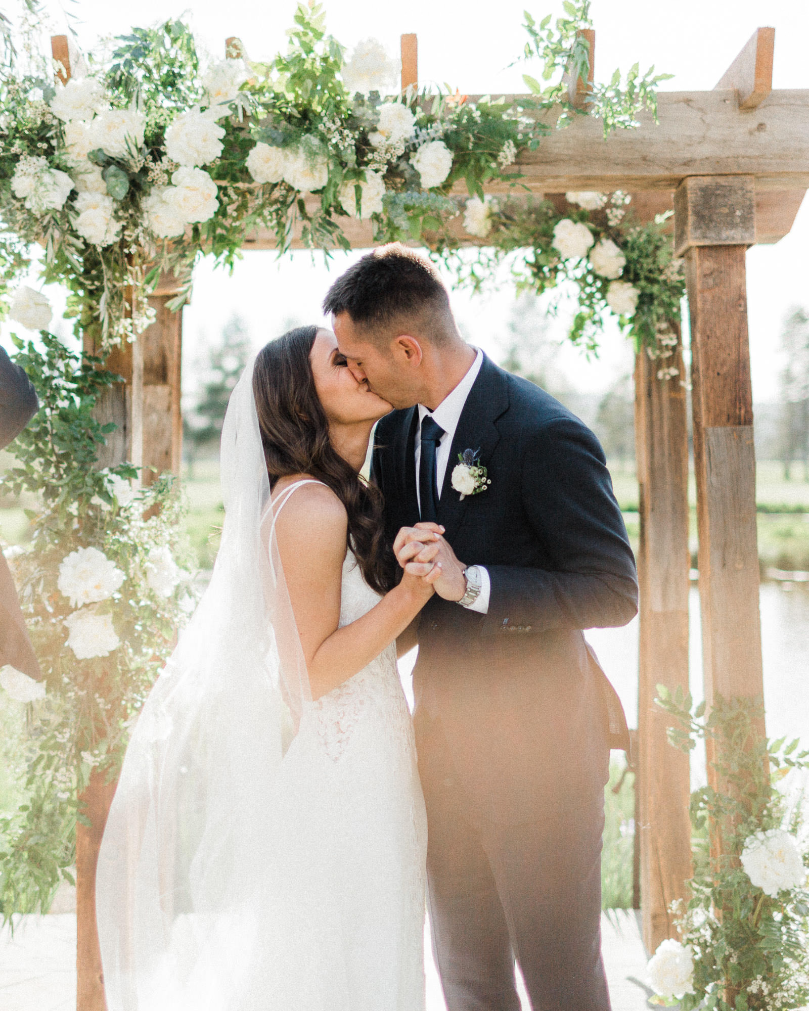 Bride and groom share first kiss at a wedding at Sunriver Resort, Oregon