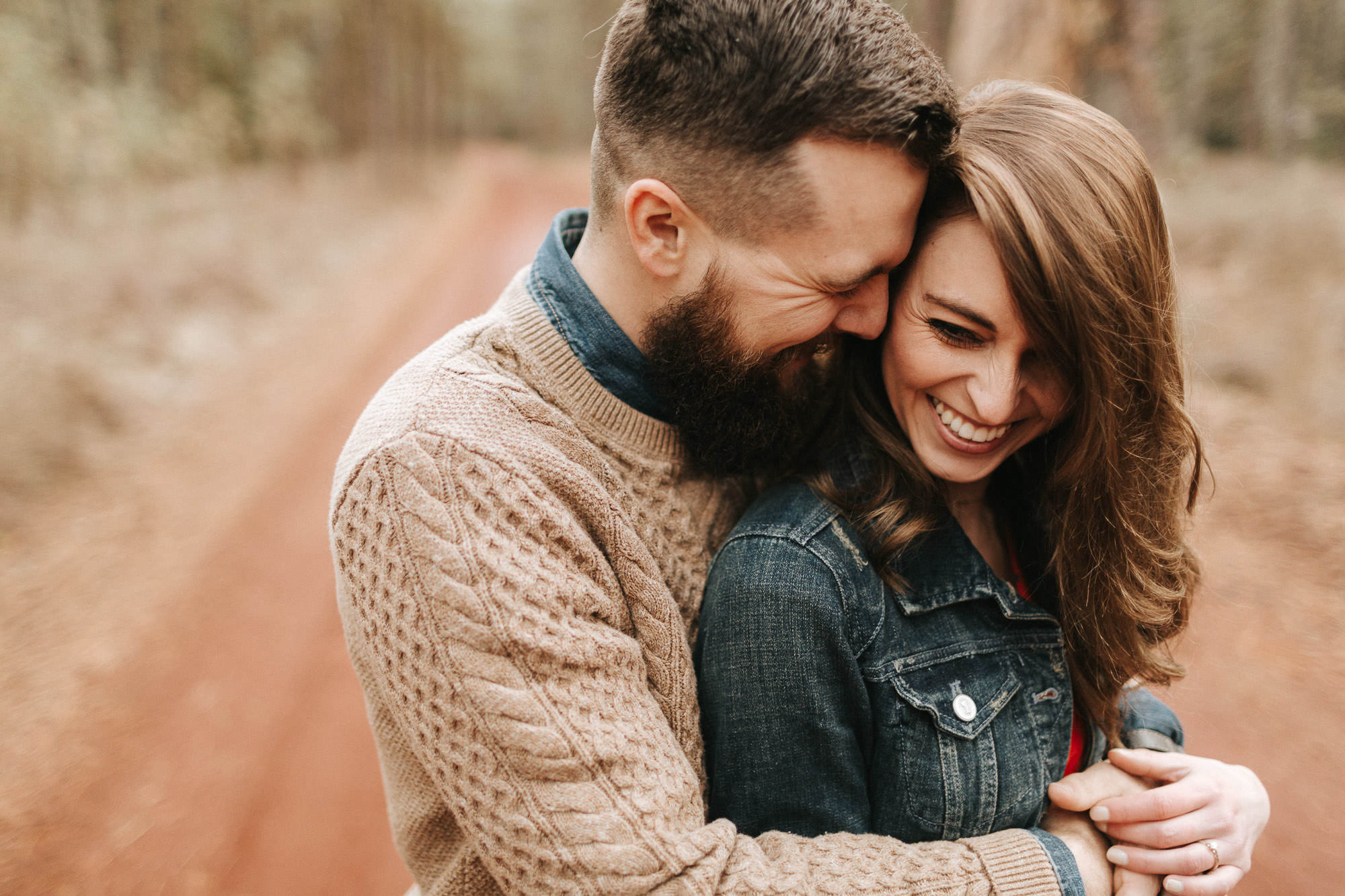 Couple embraces on forest road in Sisters, Oregon