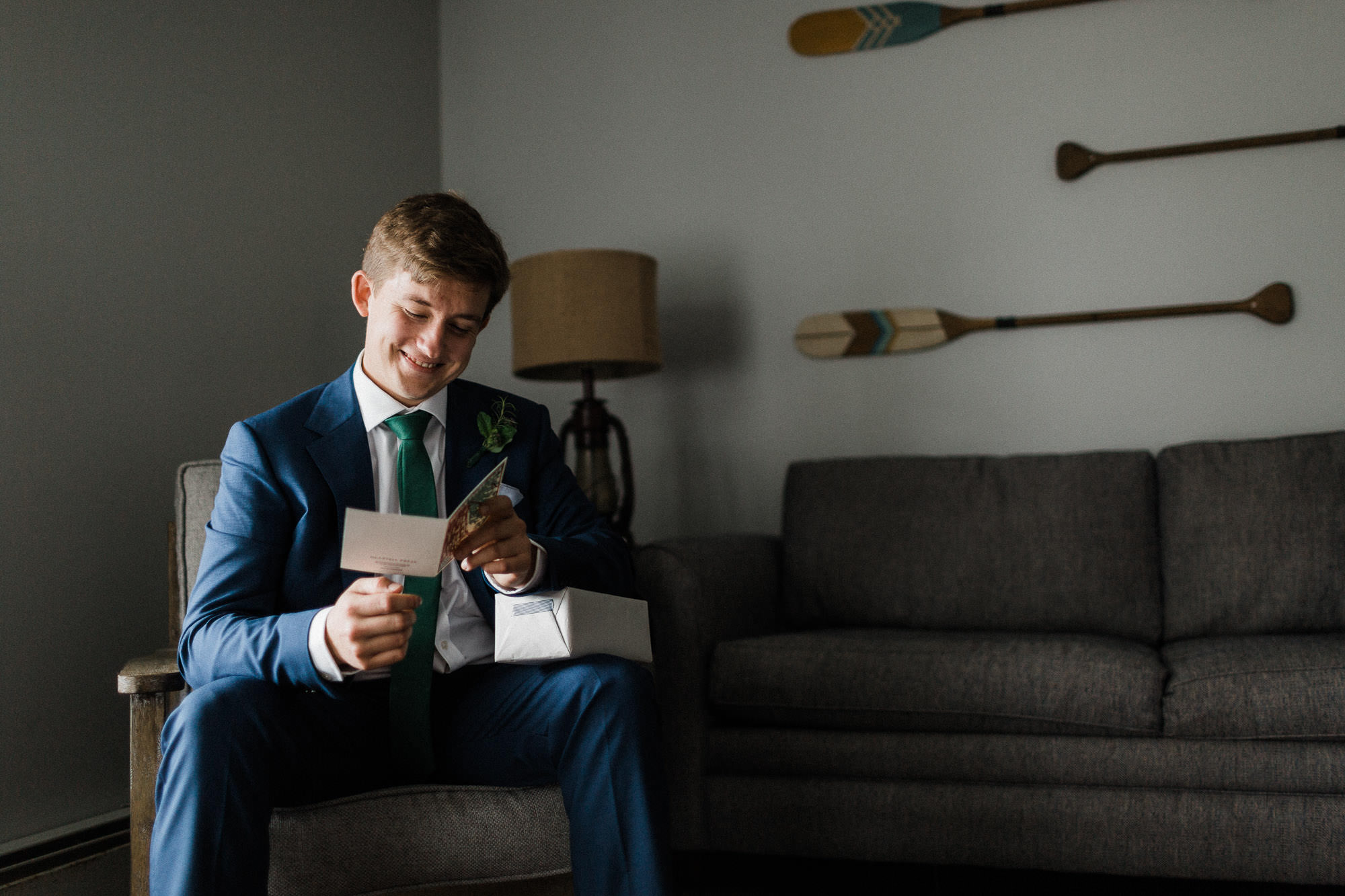 Groom reads a card from his bride at Bomoseen Lodge in Vermont