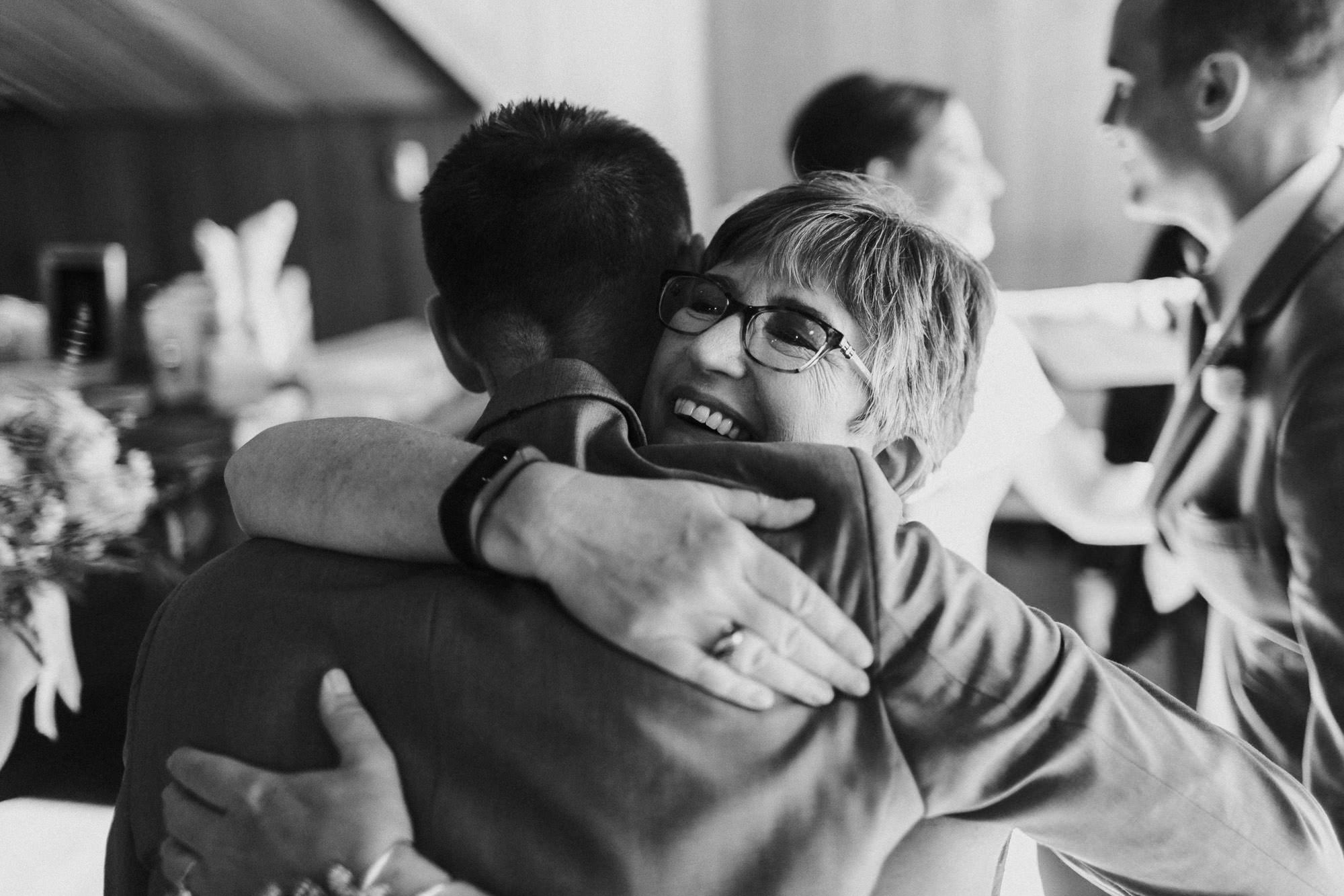 Mom hugs groom after wedding ceremony at Black Butte Ranch in Oregon