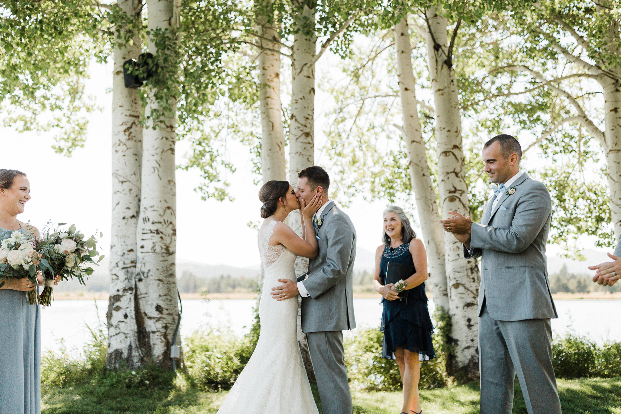 Bride and groom share their first kiss at Black Butte Ranch in Central Oregon