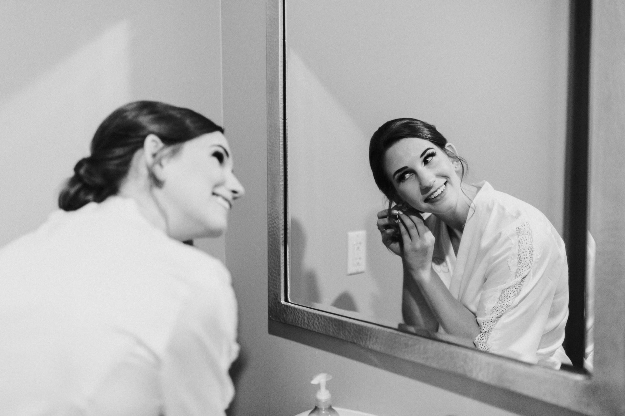 Bride puts her earrings on at Black Butte Ranch in Oregon