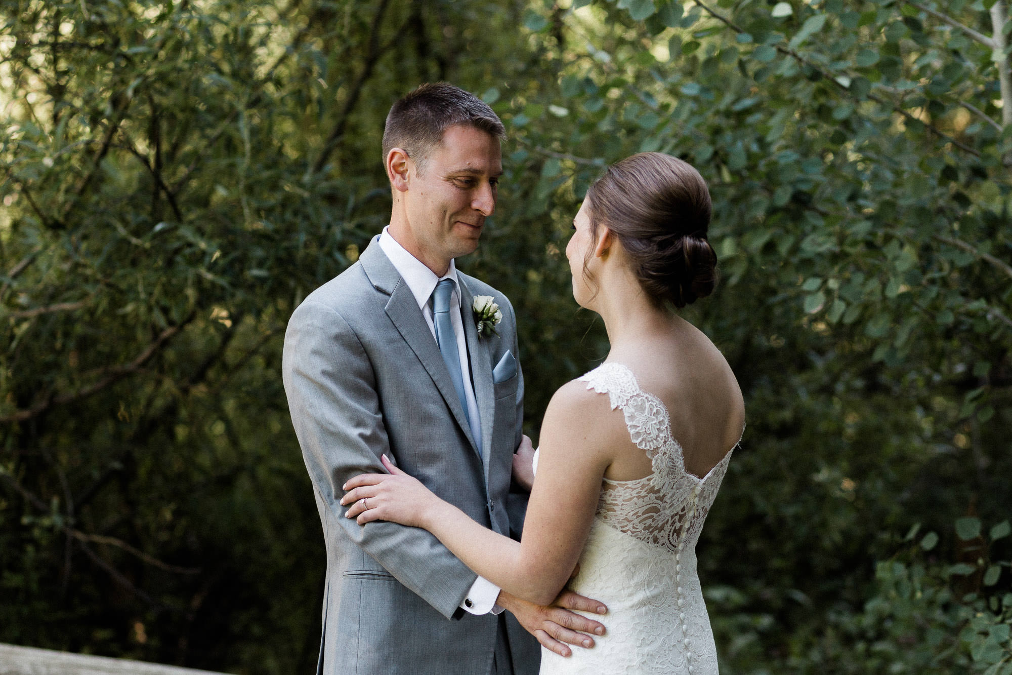 Groom reacts with misty eyes after seeing his bride for the first time on their wedding day