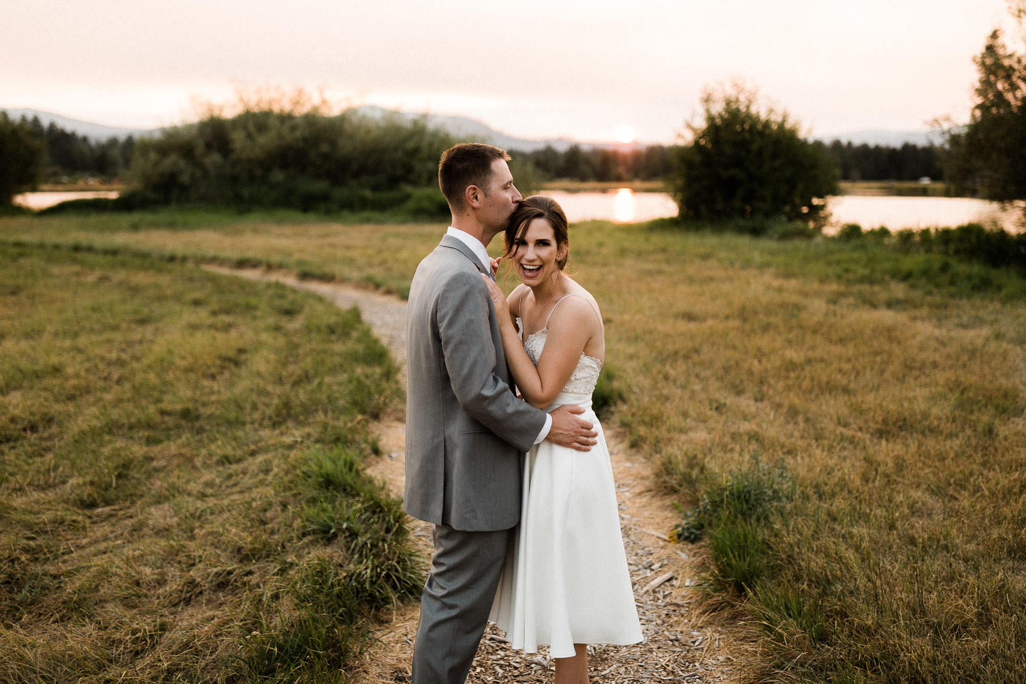 Bride and groom pose on a trail during sunset at Black Butte Ranch 