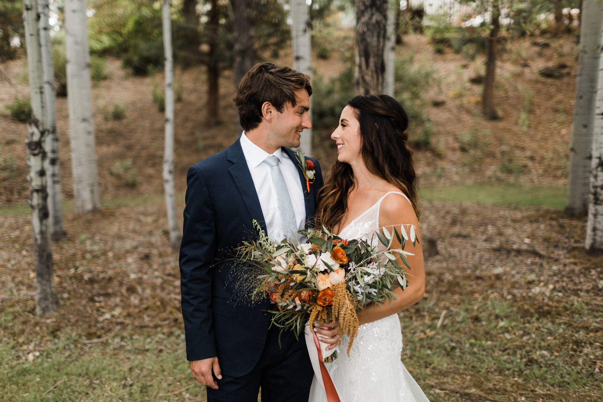 Bride and groom look at each other outside at Broken Top Club in Bend, Oregon
