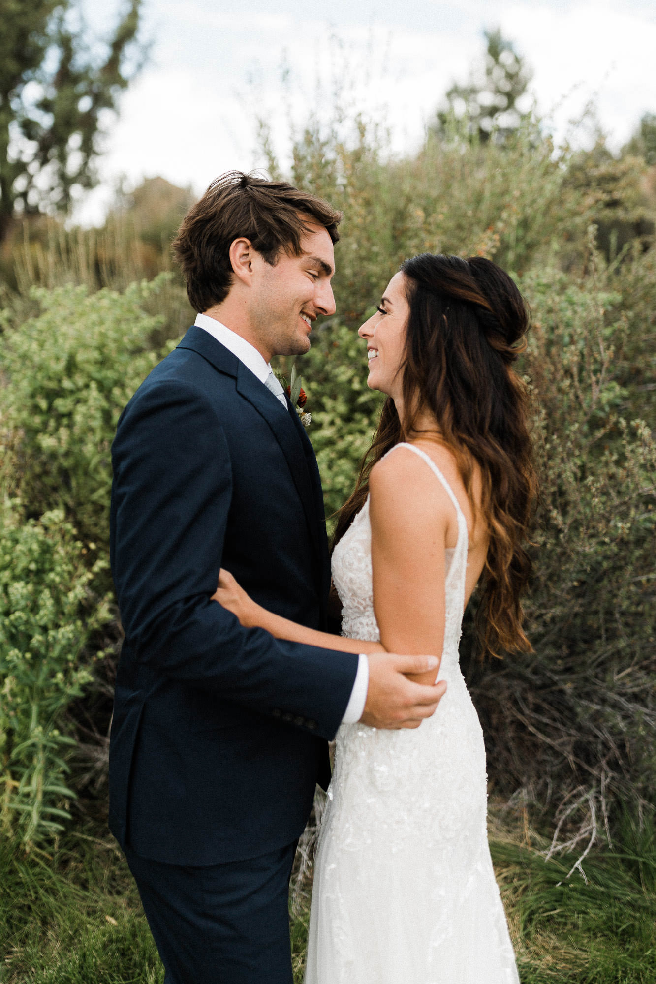 Bride and groom embrace outside at Broken Top Club in Bend, Oregon