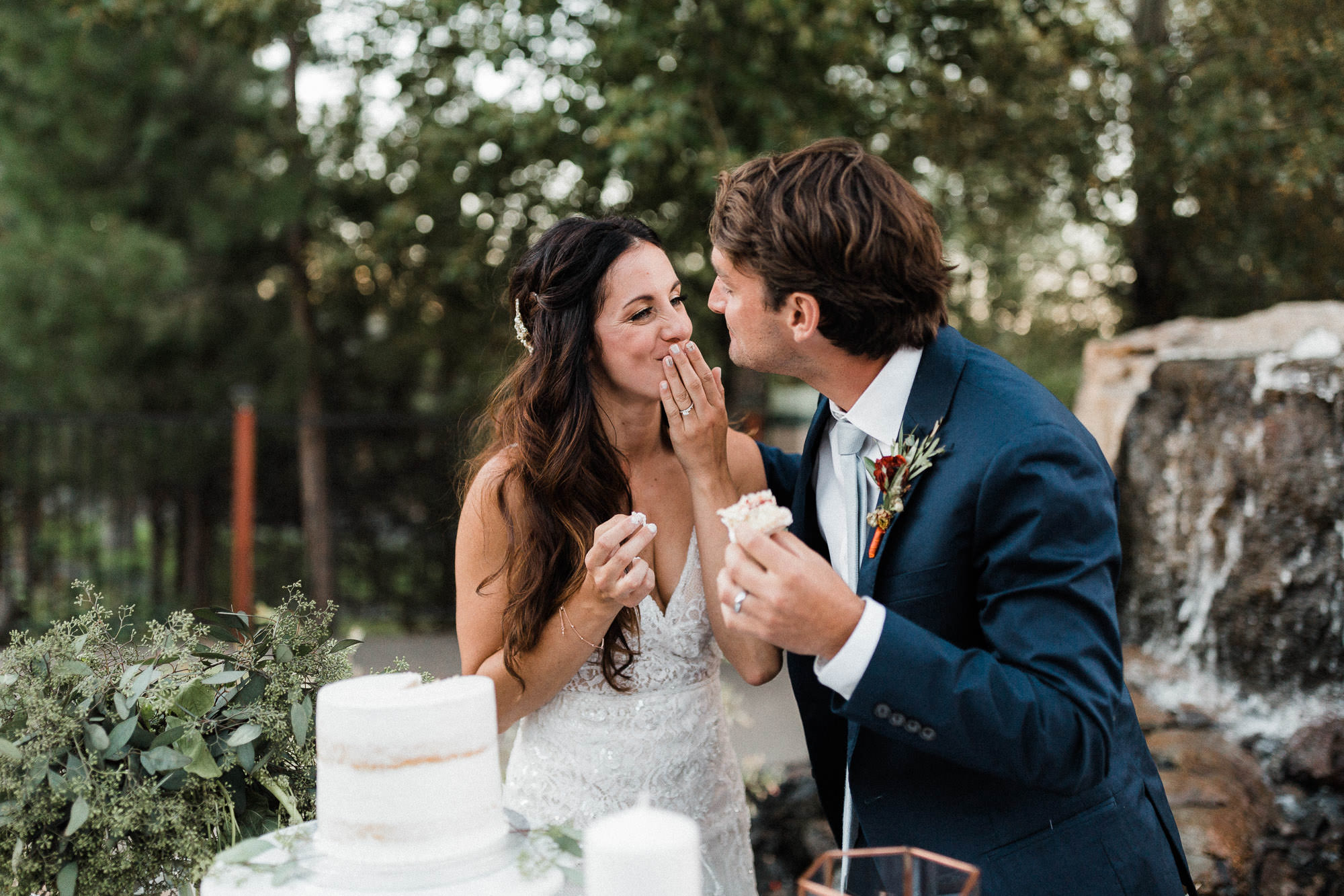 Bride and groom feed each other cake at Broken Top Club in Bend, Oregon