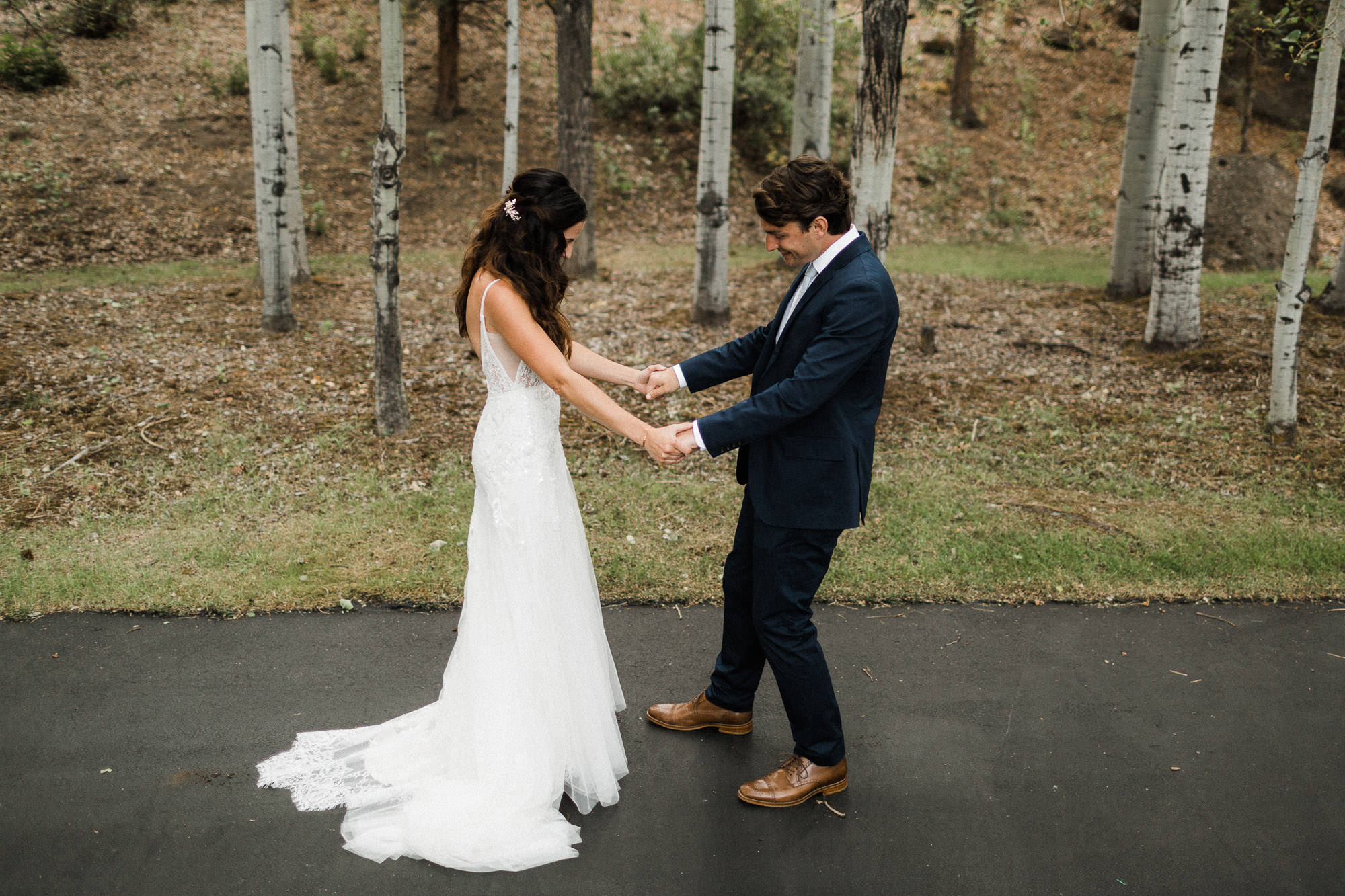 Groom admires bride during first look at Broken Top Club in Bend, Oregon