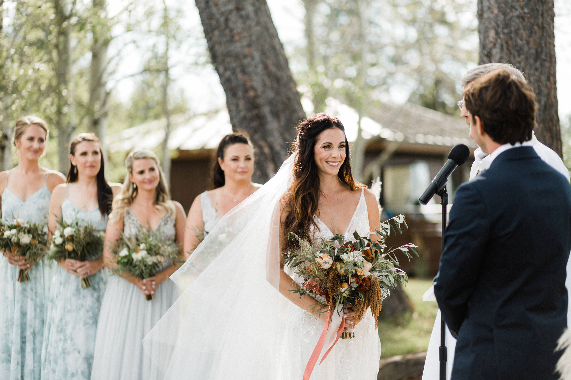 Bride smiles during wedding ceremony at Broken Top Club in Bend, Oregon