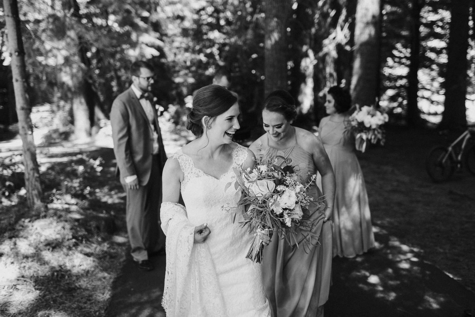 The wedding party walks and laughs at Black Butte Ranch in Oregon