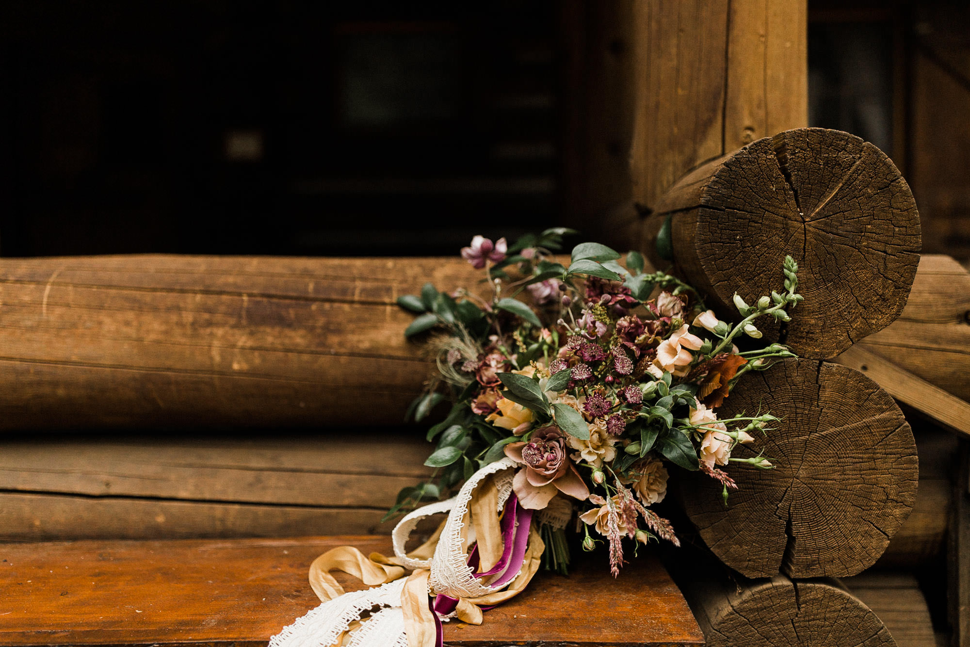 A bride's bouquet rests on a bench in front of Skyliner Lodge in Bend, Oregon