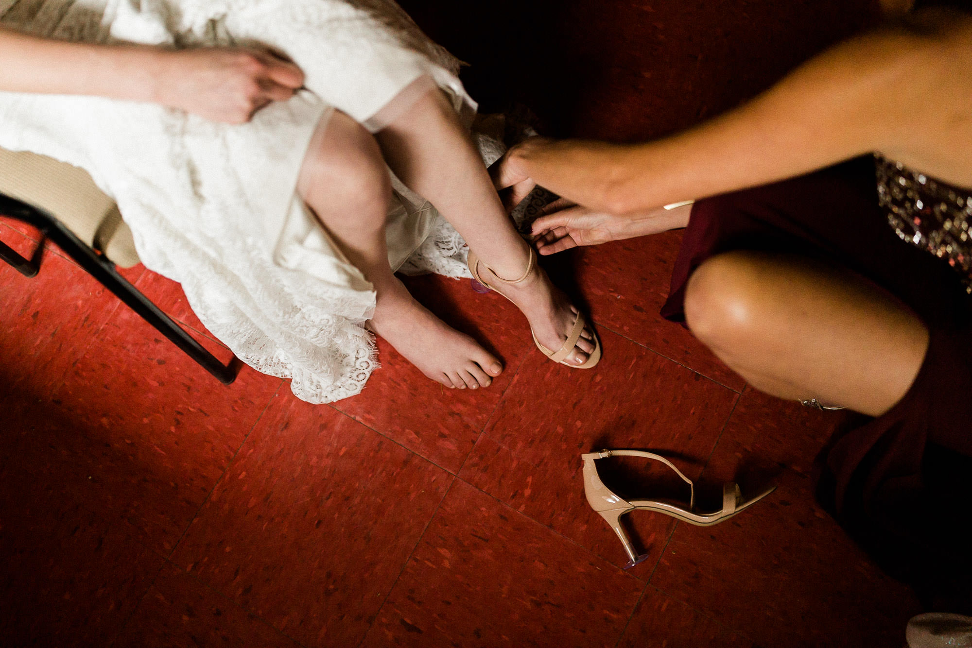 Mom helps bride put shoes on at Skyliner Lodge in Bend, Oregon