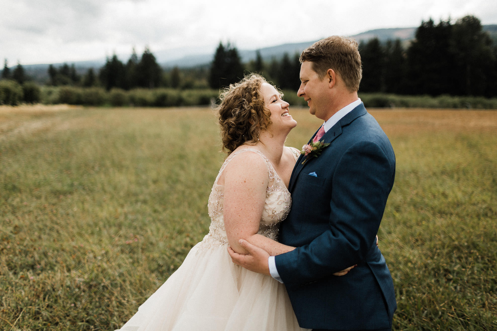 Bride and groom embrace after their "first look" at Mt. View Orchards in Mt Hood, Oregon.