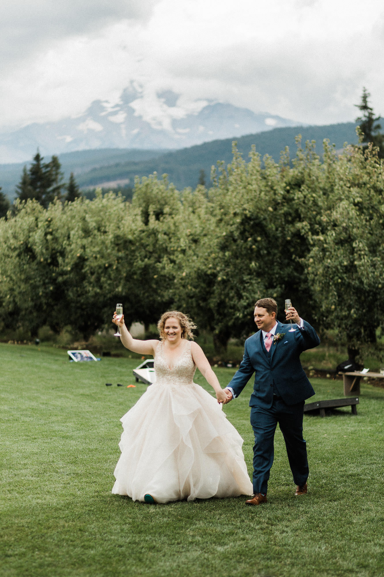 The bride and groom raise their champagne glasses as the arrive at the reception.