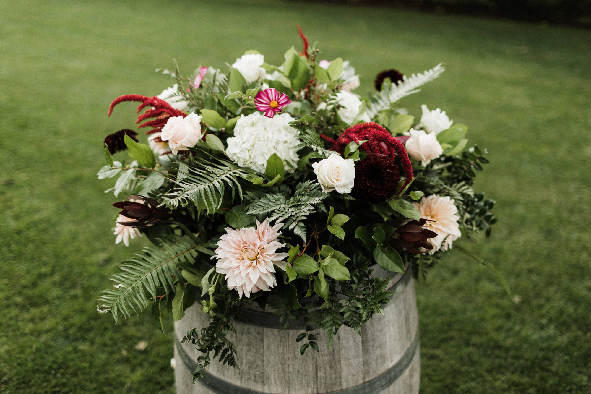 A flower arrangement sits on top of a wine barrel at Mt. View Orchards.