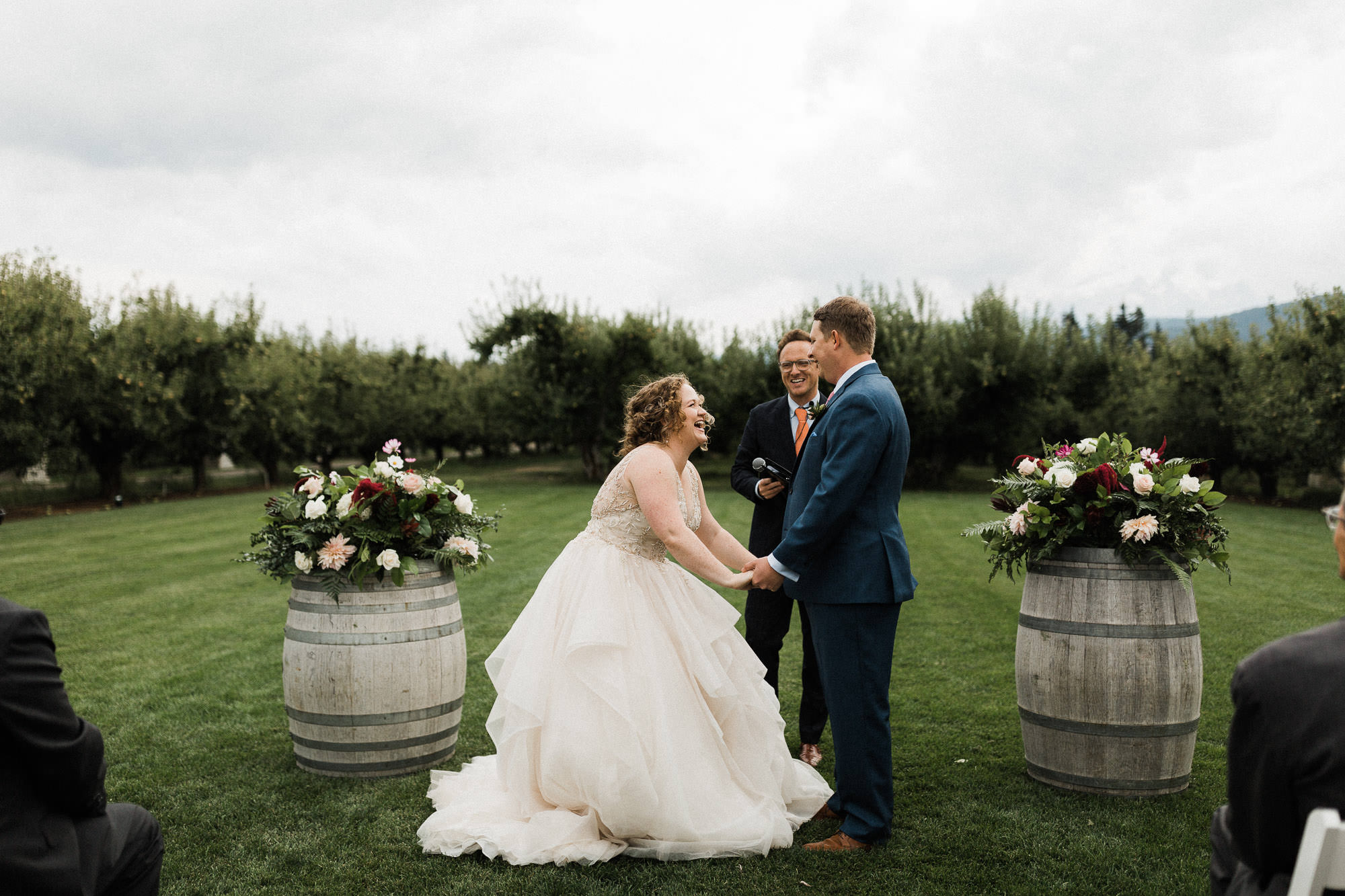 The bride and groom laugh during their wedding ceremony at Mt. View Orchards.