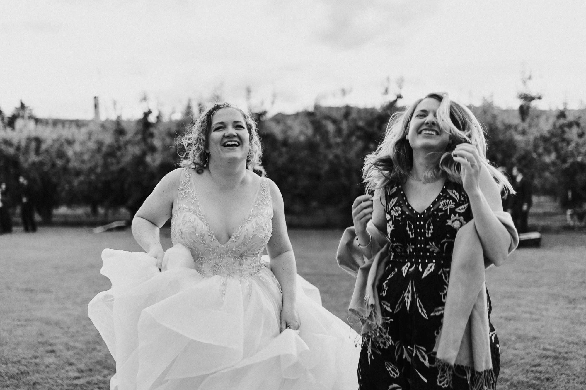 The bride and a wedding guest dance at Mt. View Orchards in Mt Hood, Oregon.