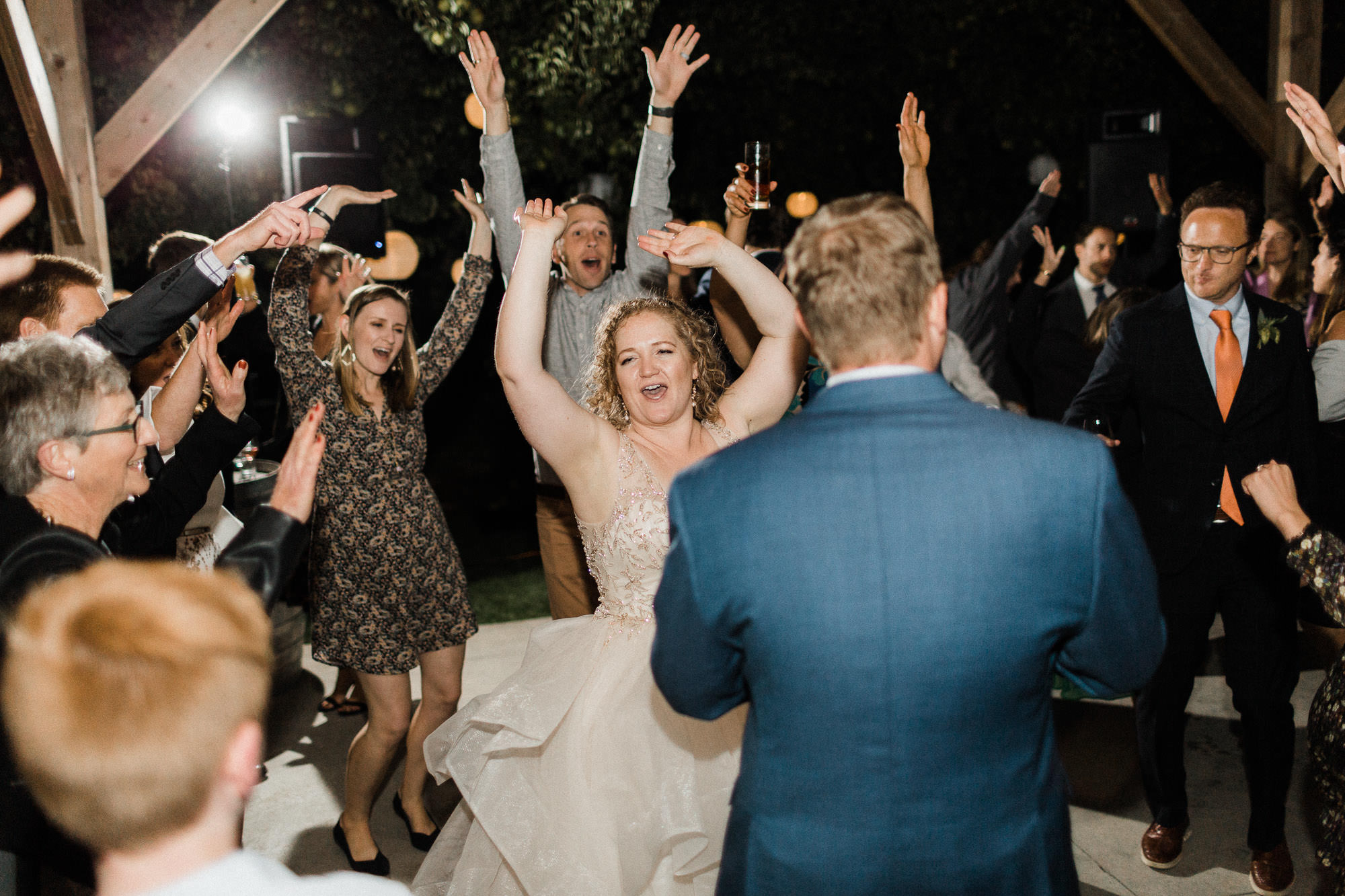 The bride and groom dance with guests at Mt. View Orchards in Oregon.