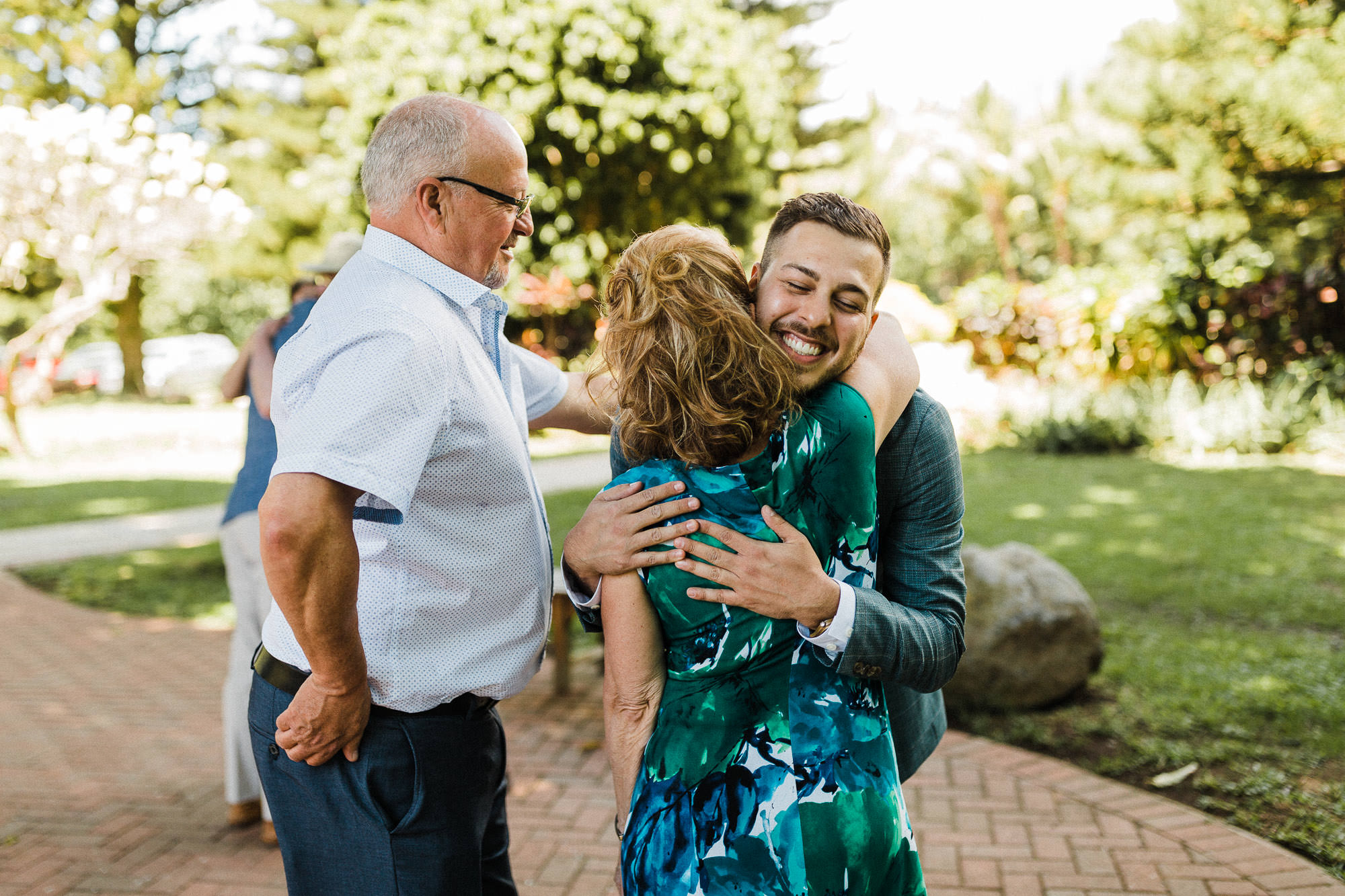 gay-wedding-hugging-family 