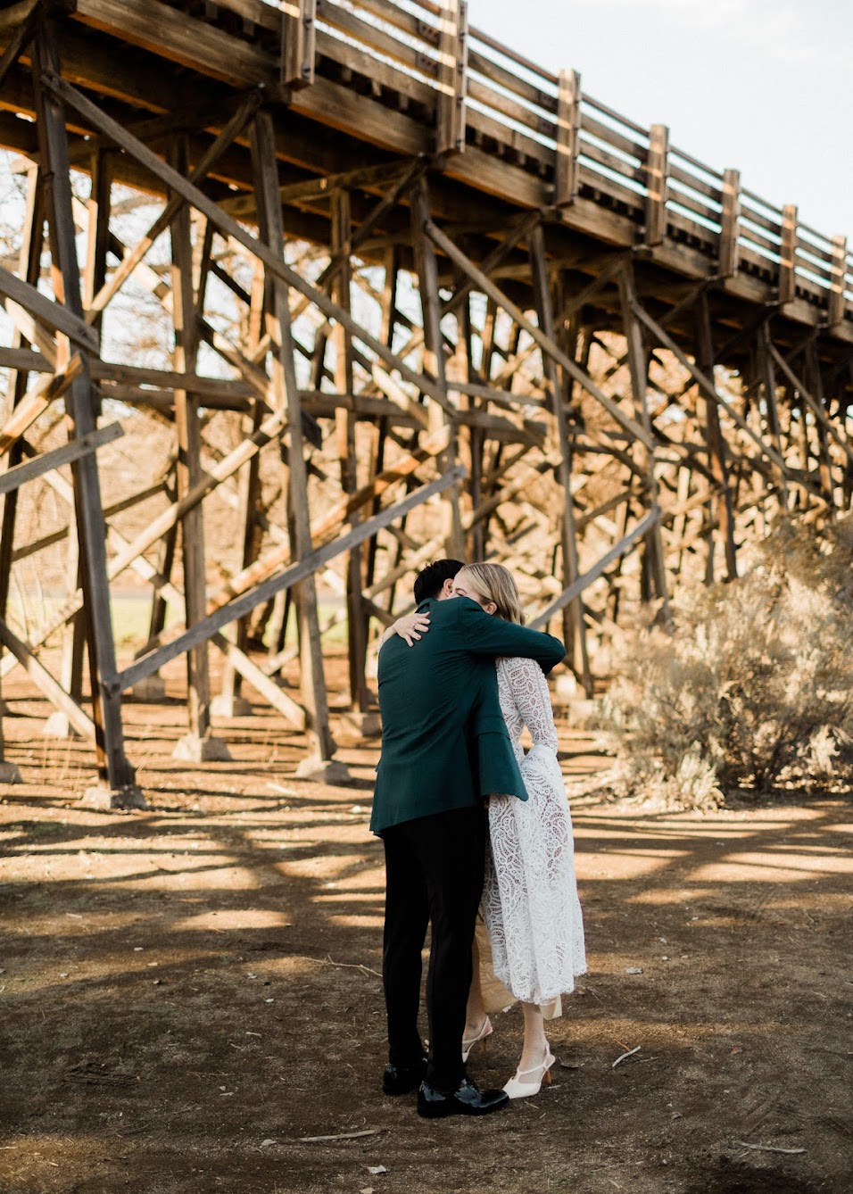 The bride and groom are hugging. 