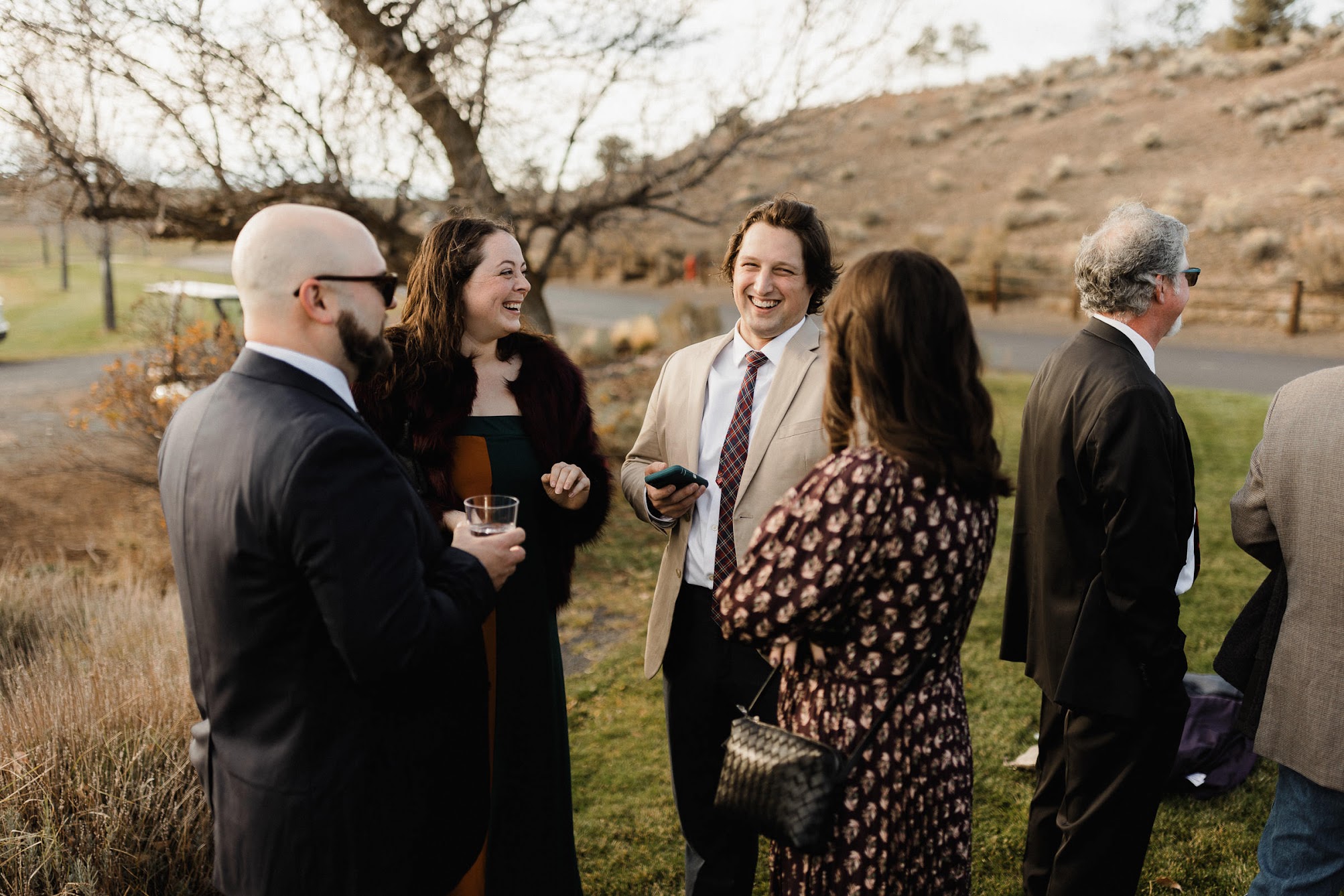 Guests laughing with drinks in their hands.