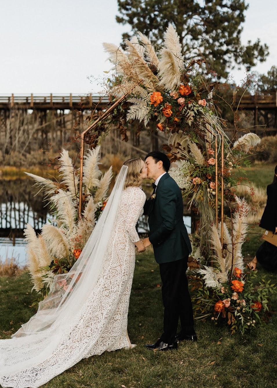 The bride and groom kiss at the arbor, and they are officially married! 