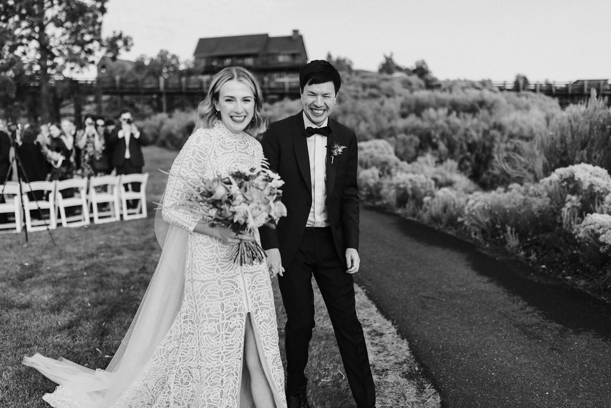 The bride and groom holding hands smiling 