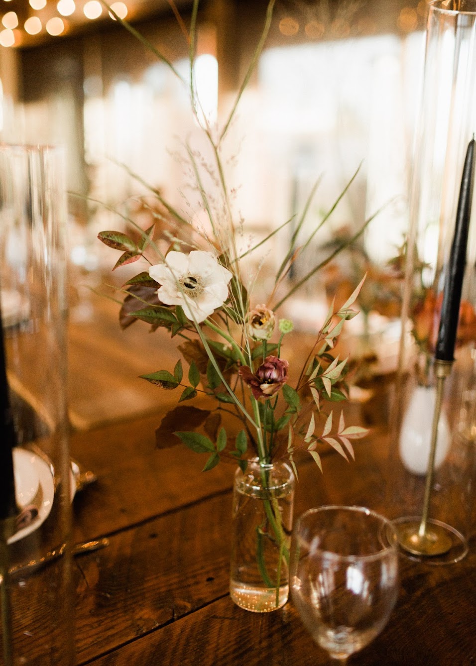 small class bud vases with wildflowers coming out of them