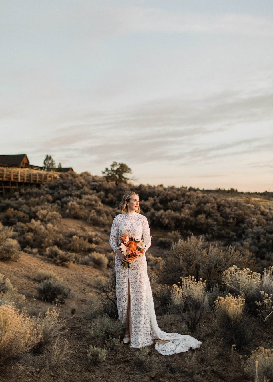 The bride standing the high dessert looking out into the distance 