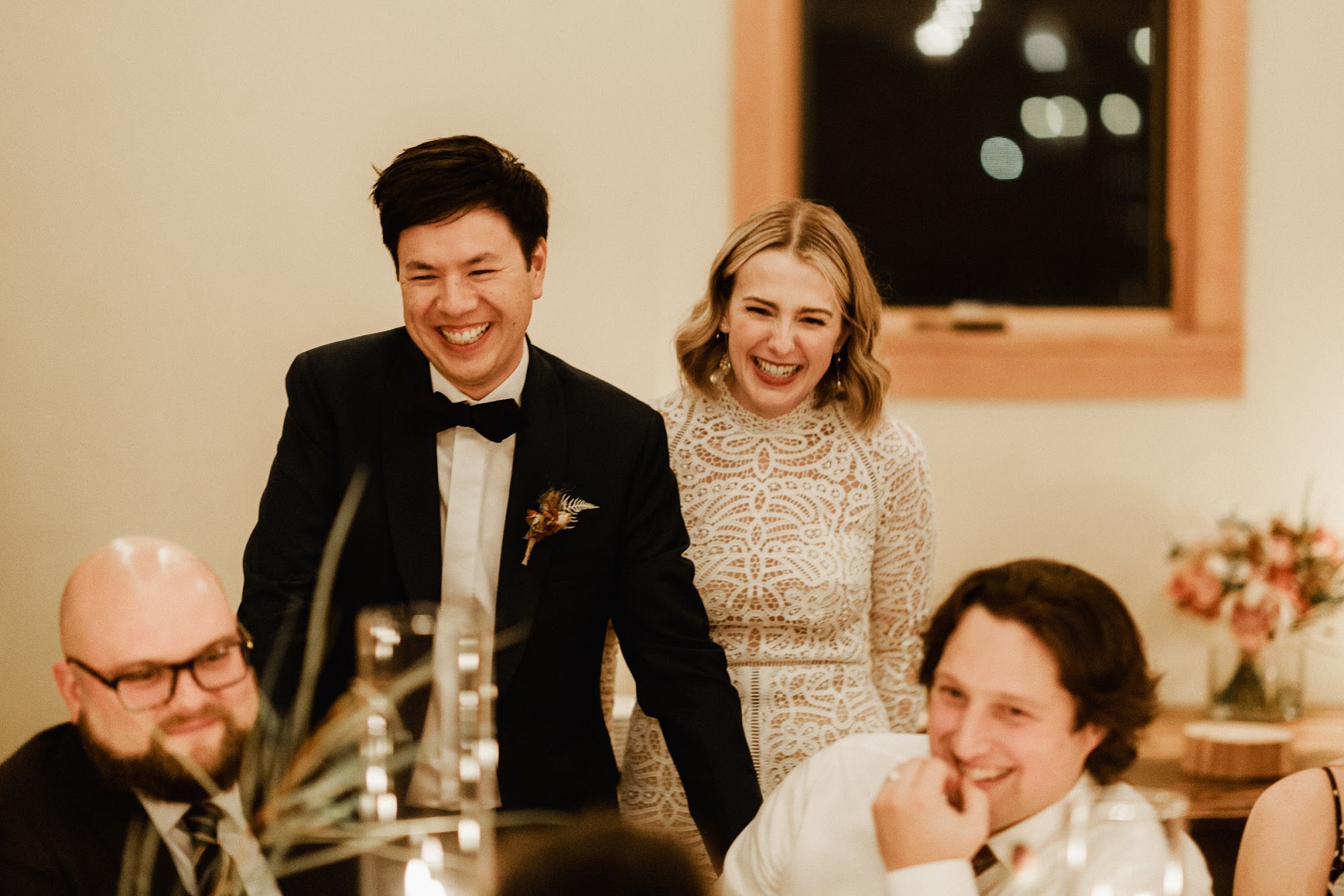 Action shot of the bride and groom laughing 