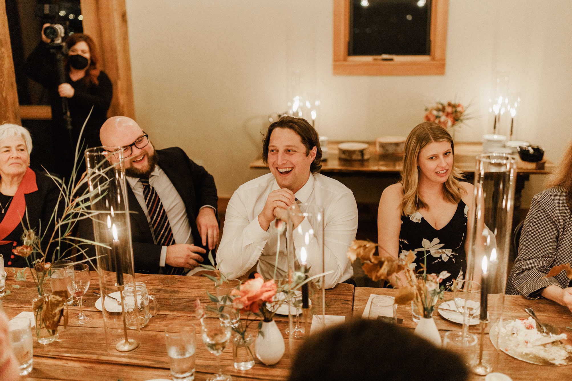 guests sitting at the tables laughing  