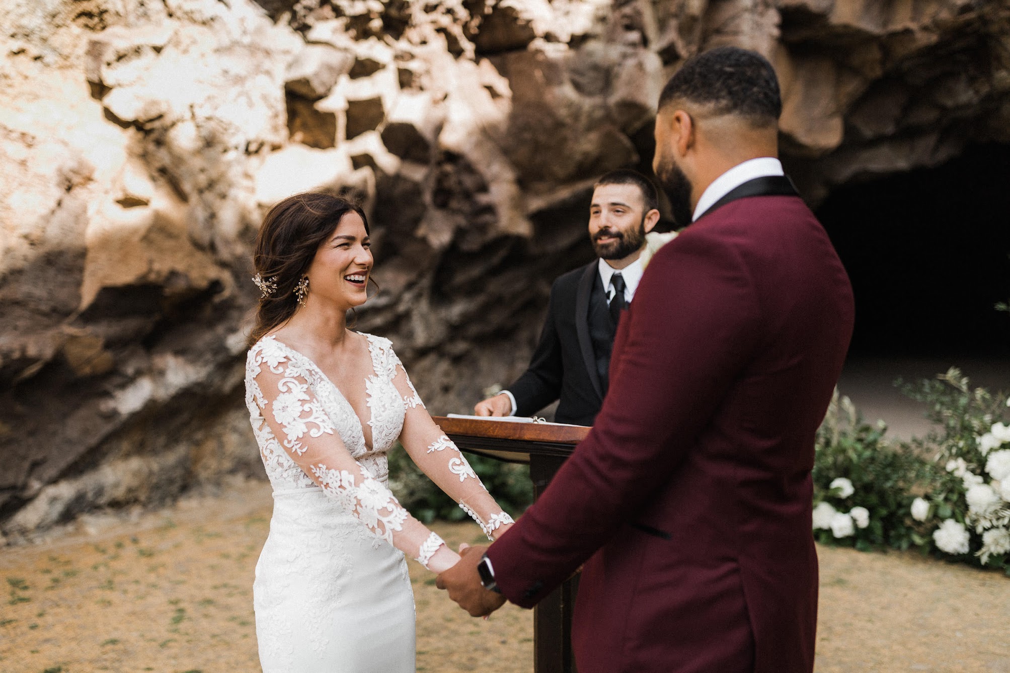bride laughing while she hold the grooms hands. 