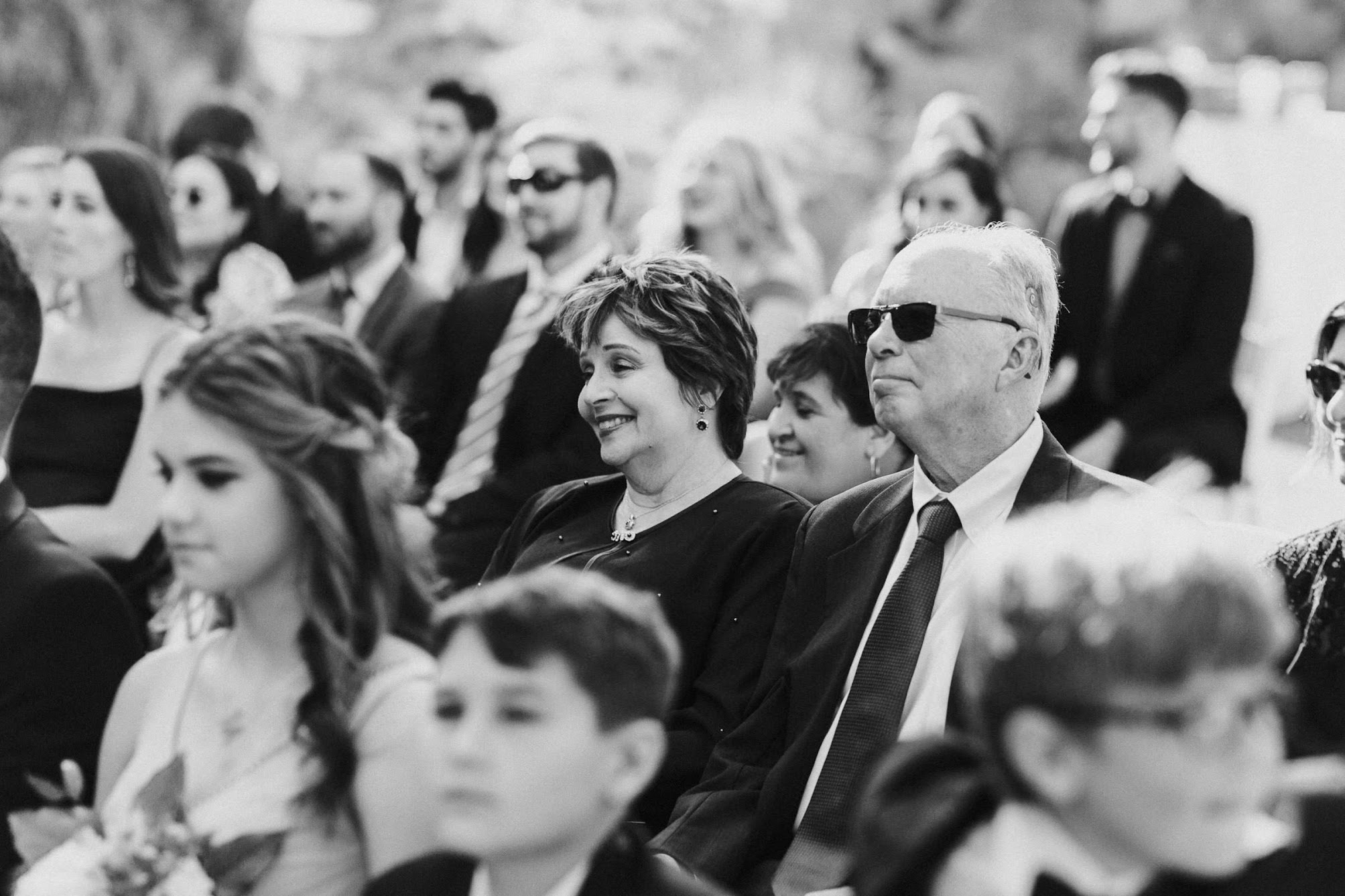 all of their guests watching as they get married, sharing a laugh.