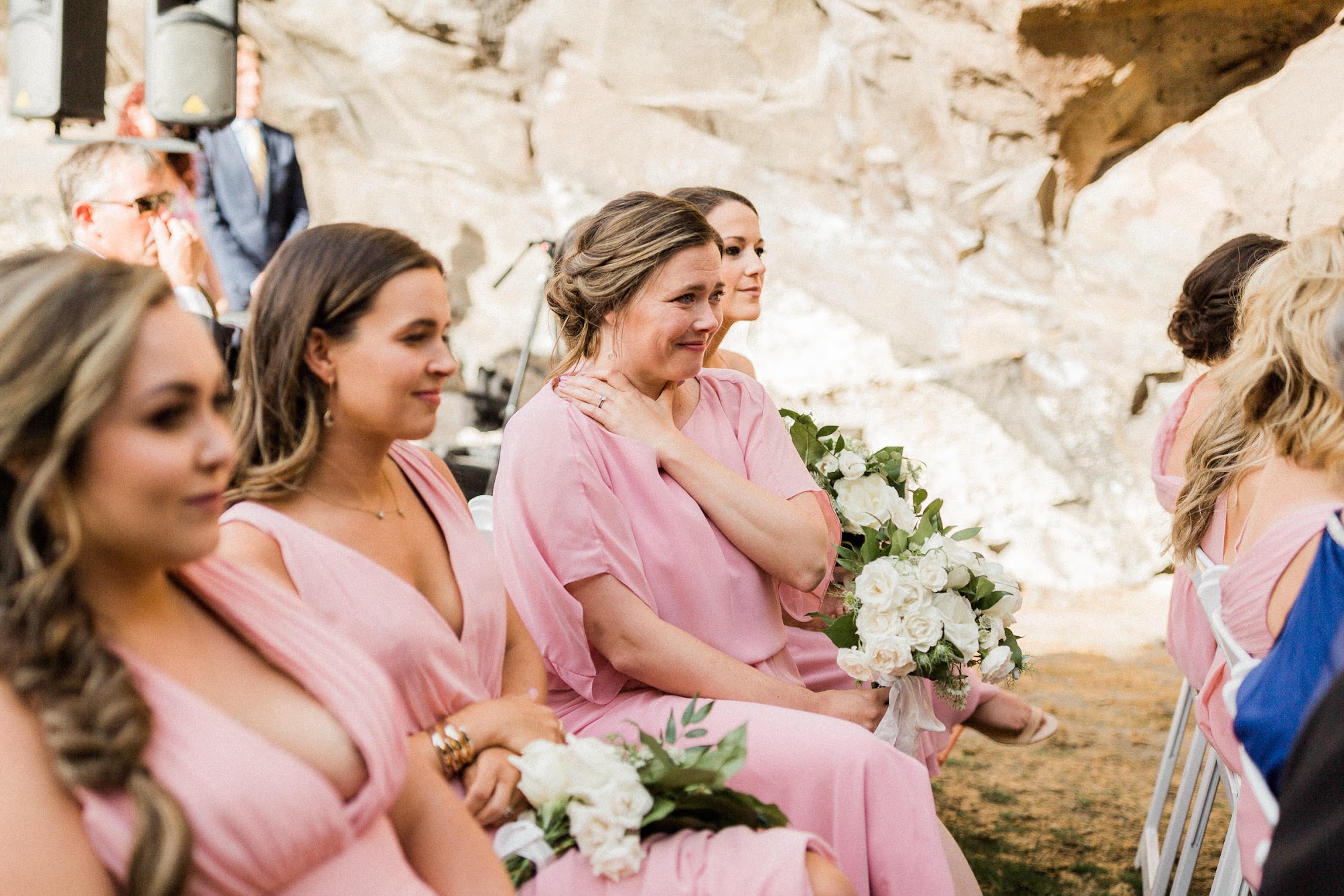 the bridesmaids all sitting down, sharing the moment with each other.  
