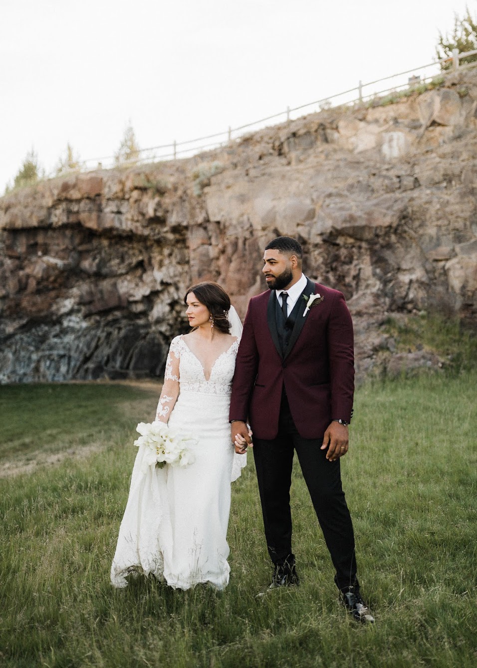 the couple holding hands staring off into the distance.