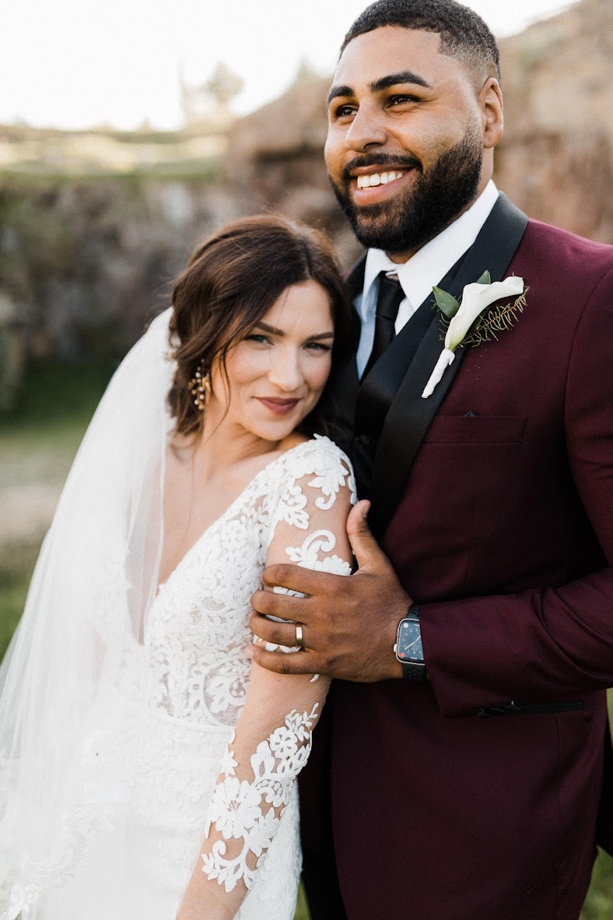 the smiling white her groom holds her 