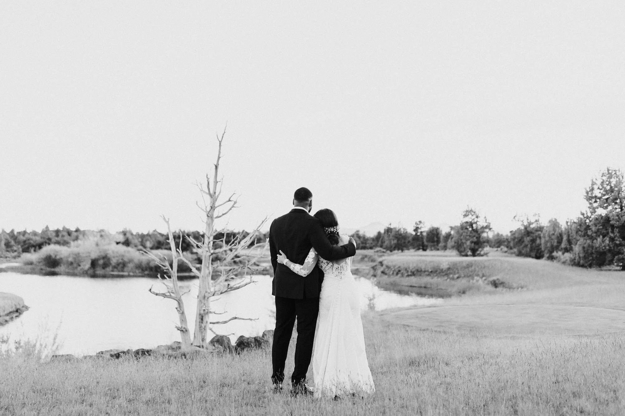 the couple with their back towards us staring at the Mountains