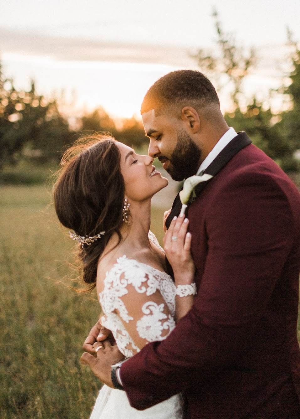 the couple holding each other close, nose to nose, almost kidding 