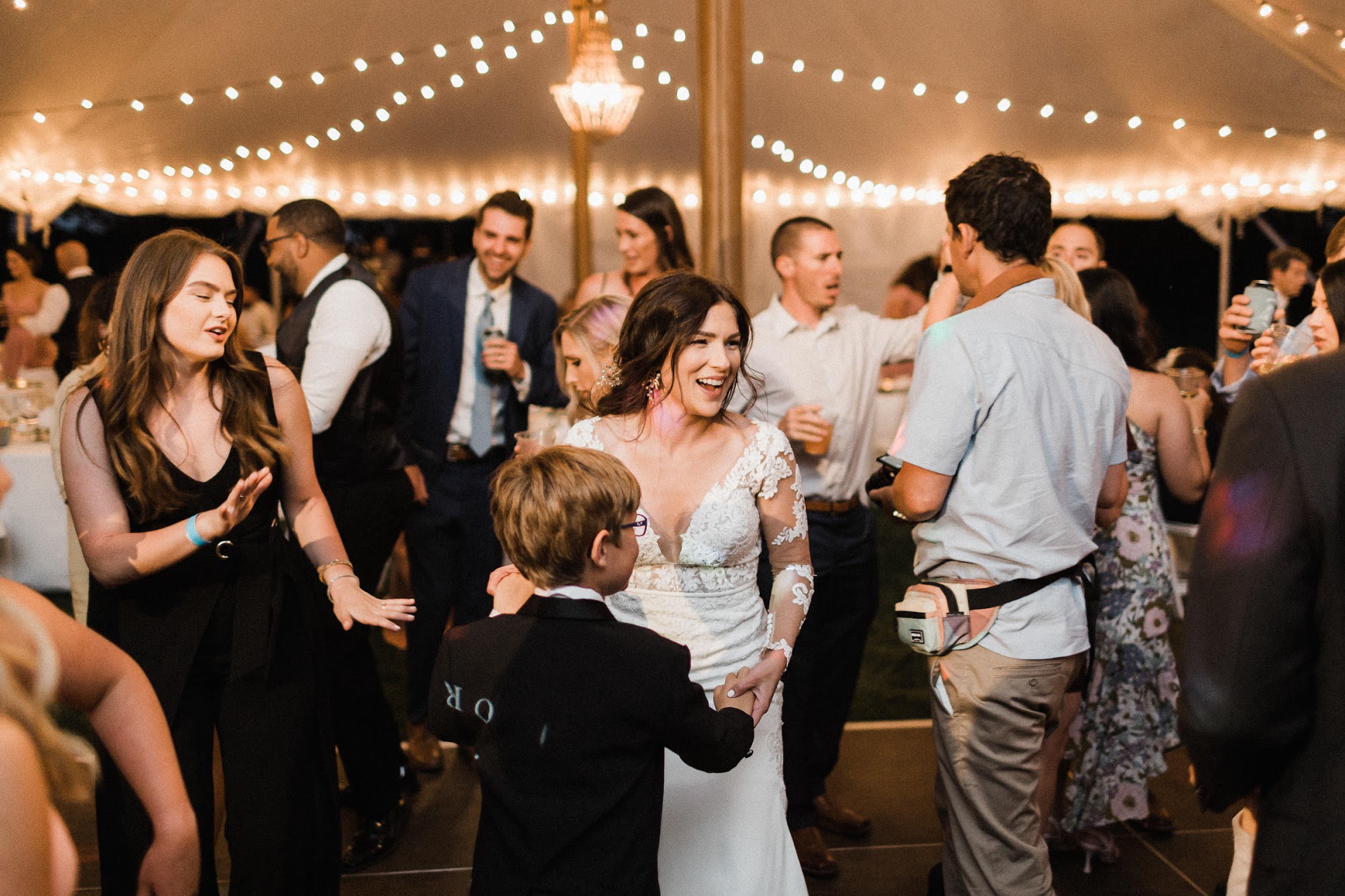 bride on the dance floor dancing with a little boy 