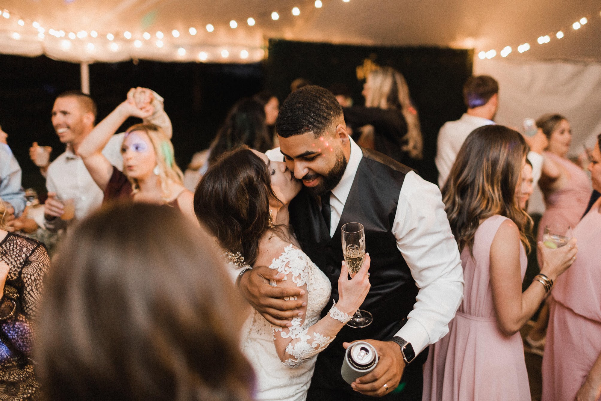 the bride kissing her husband on the check 