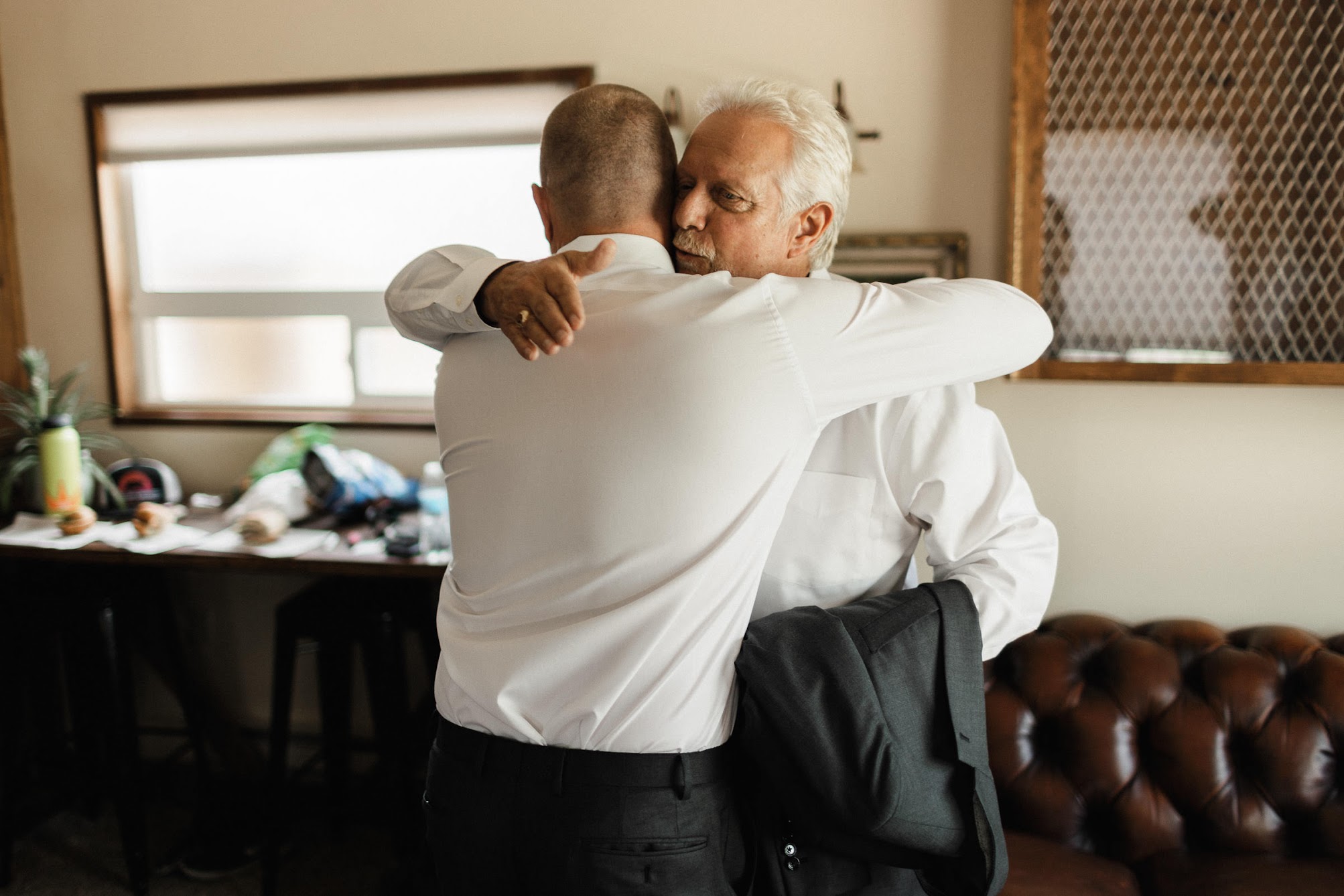 the groom and his father hugging