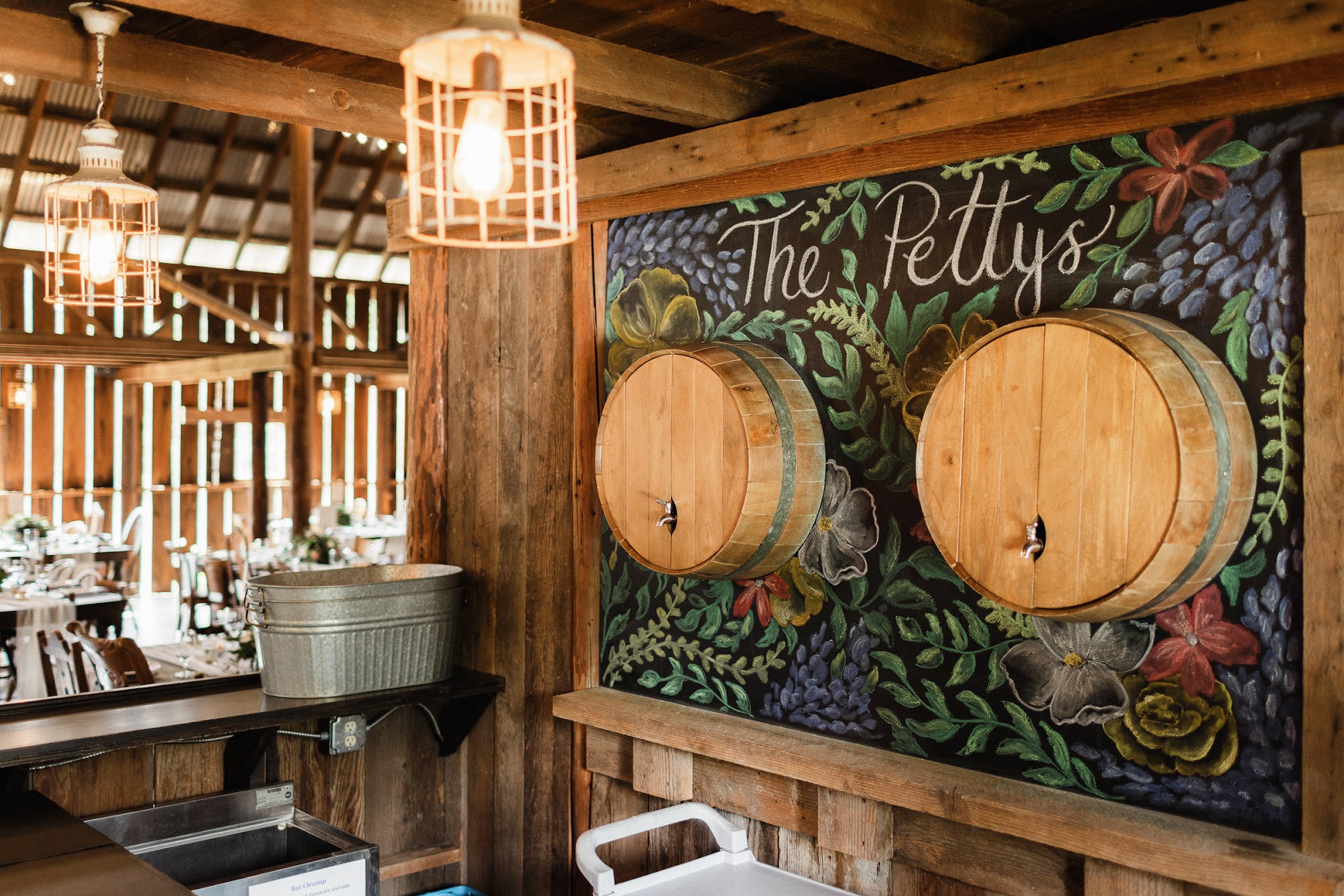 Wine barrels coming out of a wall with pourers coming out of them to pour wine.