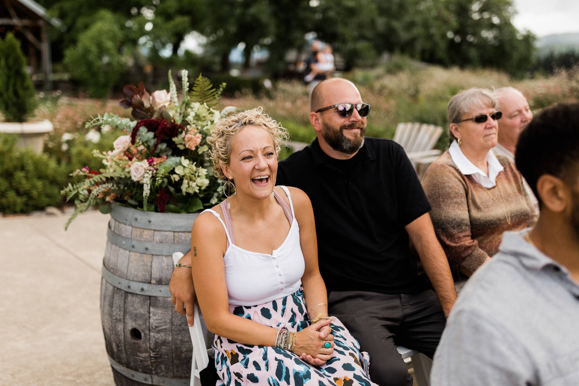 the guests are laughing and smiling as they watch the wedding ceremony. 