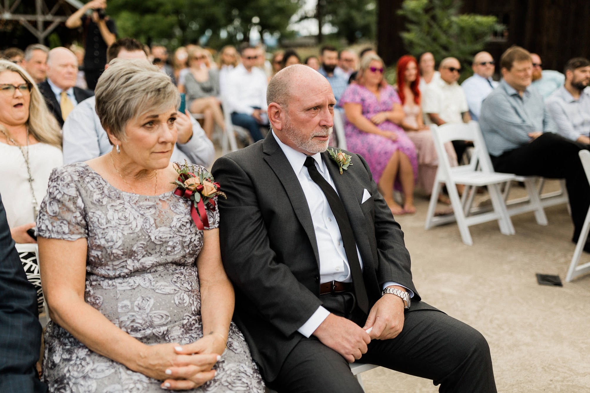 Father and mother of the bride cry tears of joy for their daughter. 