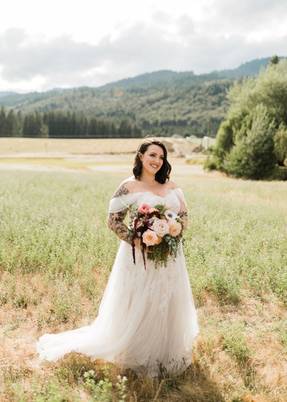 The bride in her off the shoulder tulle dress with her large bridal boutique  