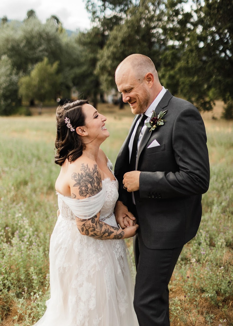 The couple looking at each other with big smiles. 