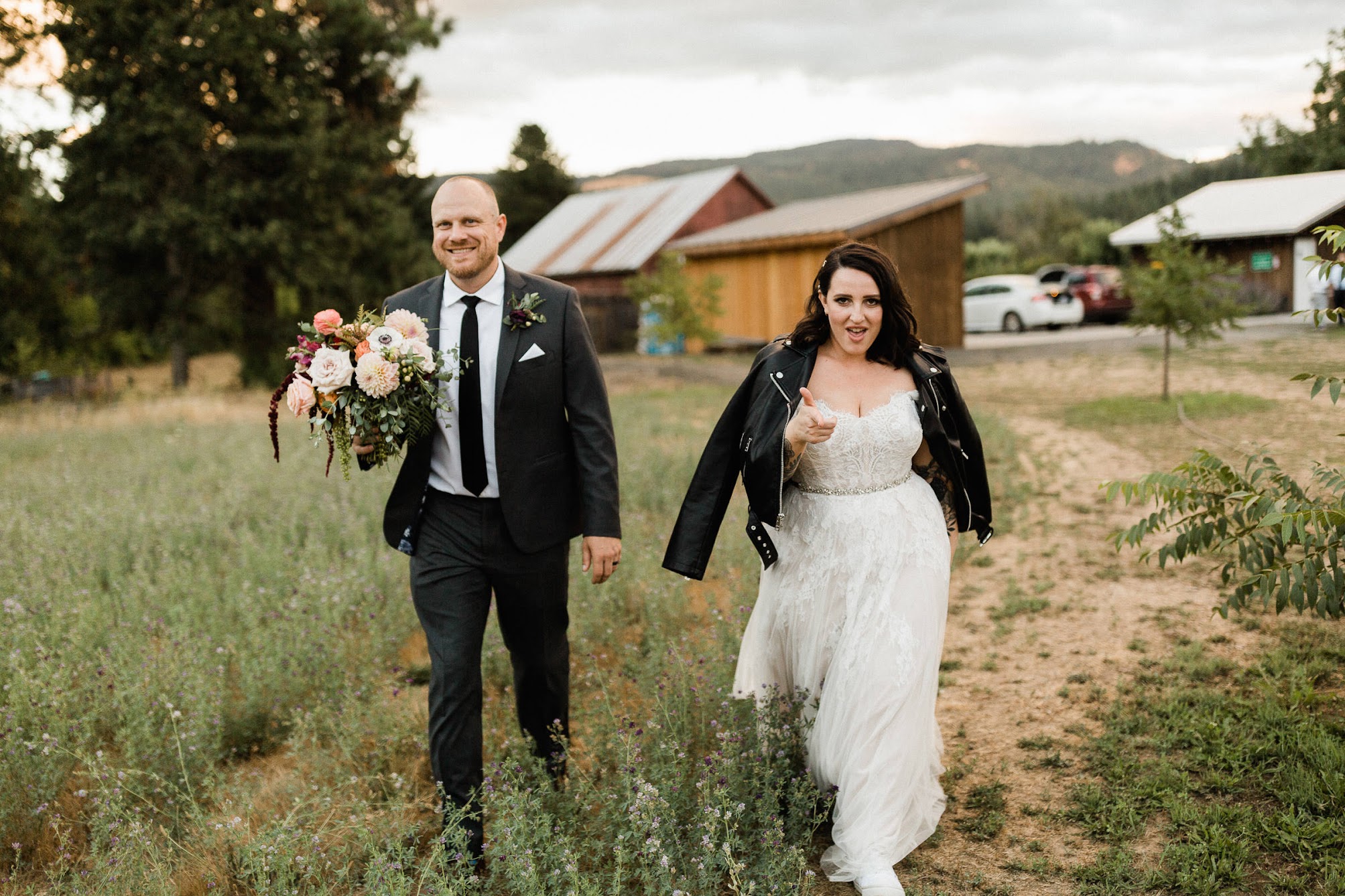 headed out for sunset photos, groom is holding the bride's bouquet.