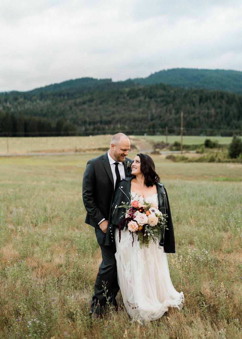 couple taking a photo together in their wedding outfits