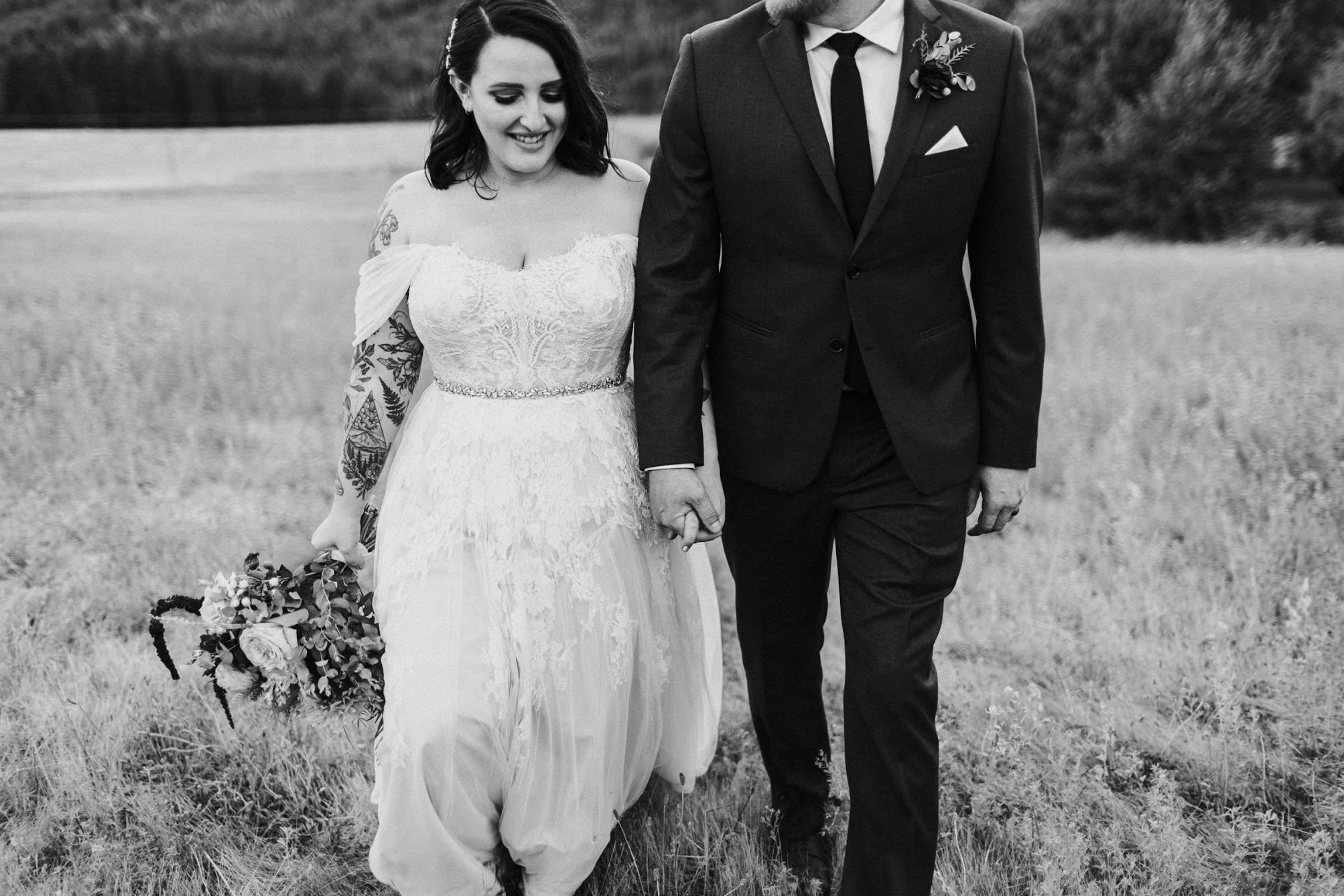 walking with together towards the camera while looking down and hold hands. 